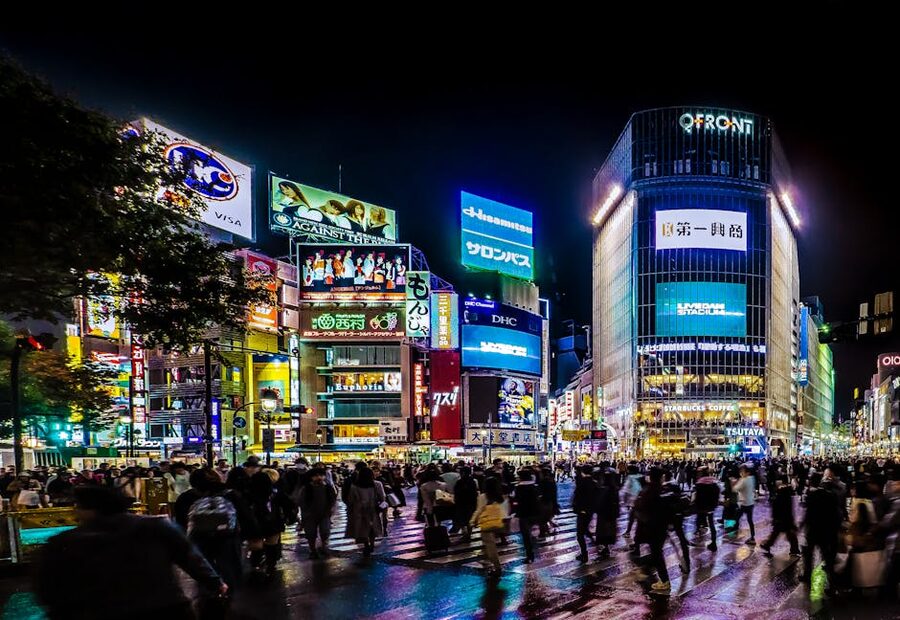 Shibuya crossing at night with neon billboards