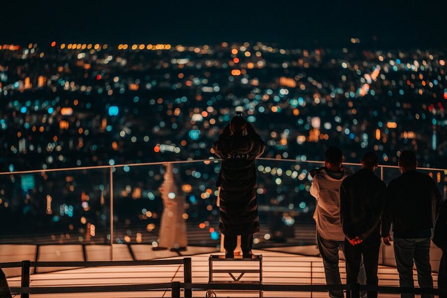 Group on a Shibuya rooftop overlooking Tokyo at night
