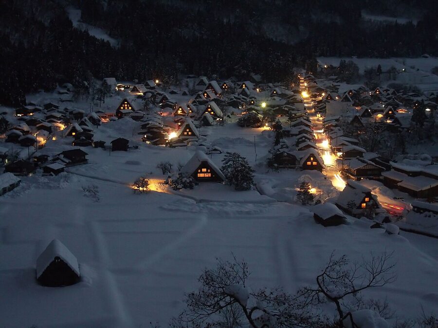 Shirakawa-go gassho-zukuri farmhouses lit from below at night during winter light-up event