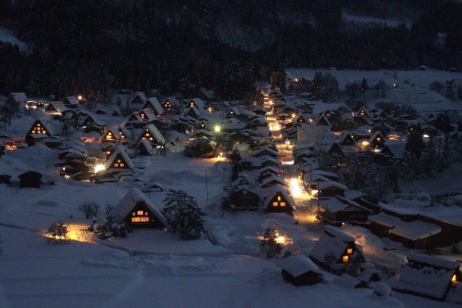 Shirakawa-go gassho-zukuri houses in winter snow with mountain backdrop