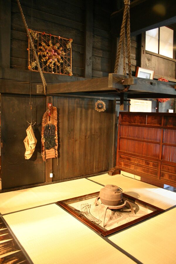 Traditional irori sunken hearth fireplace inside a gassho-zukuri farmhouse interior
