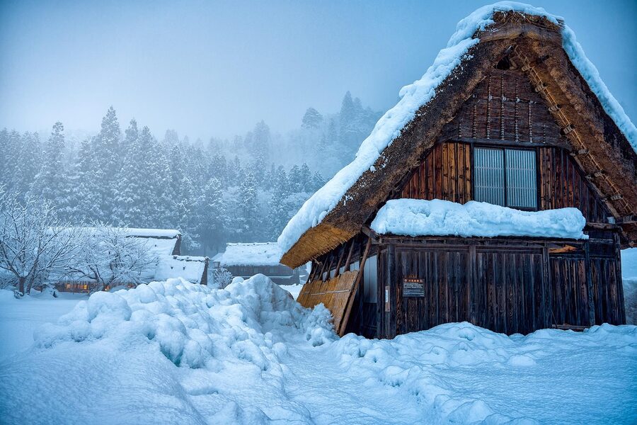 A gassho-zukuri thatched roof under heavy snow in Shirakawa-go