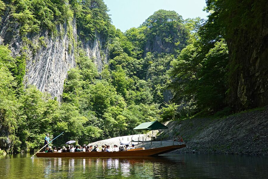 Flat-bottomed sightseeing boat on river through Geibikei Gorge, Iwate