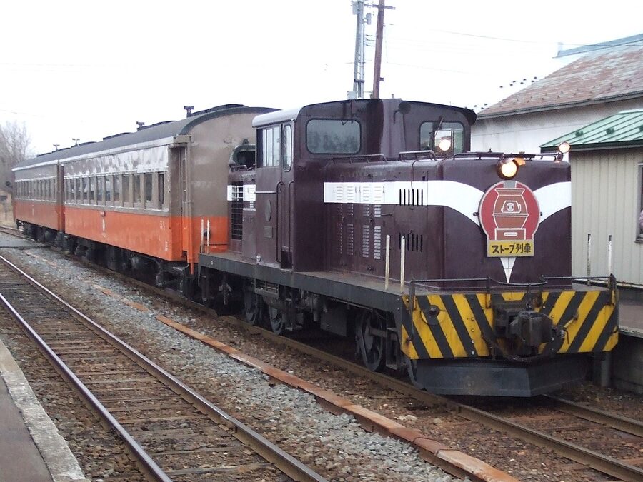 Tsugaru Railway stove train interior with cast-iron coal stove and heated dried squid
