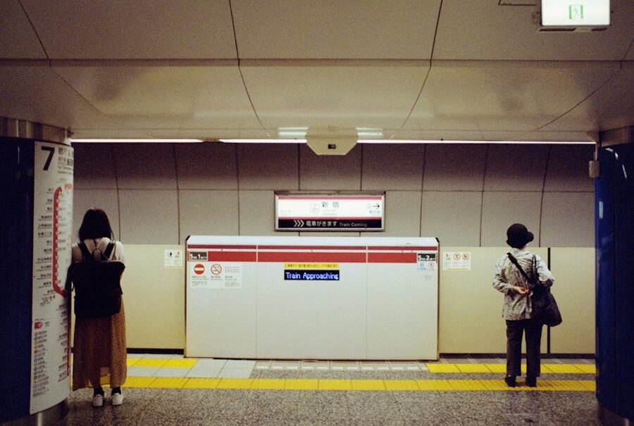 Tokyo subway station platform with commuters waiting
