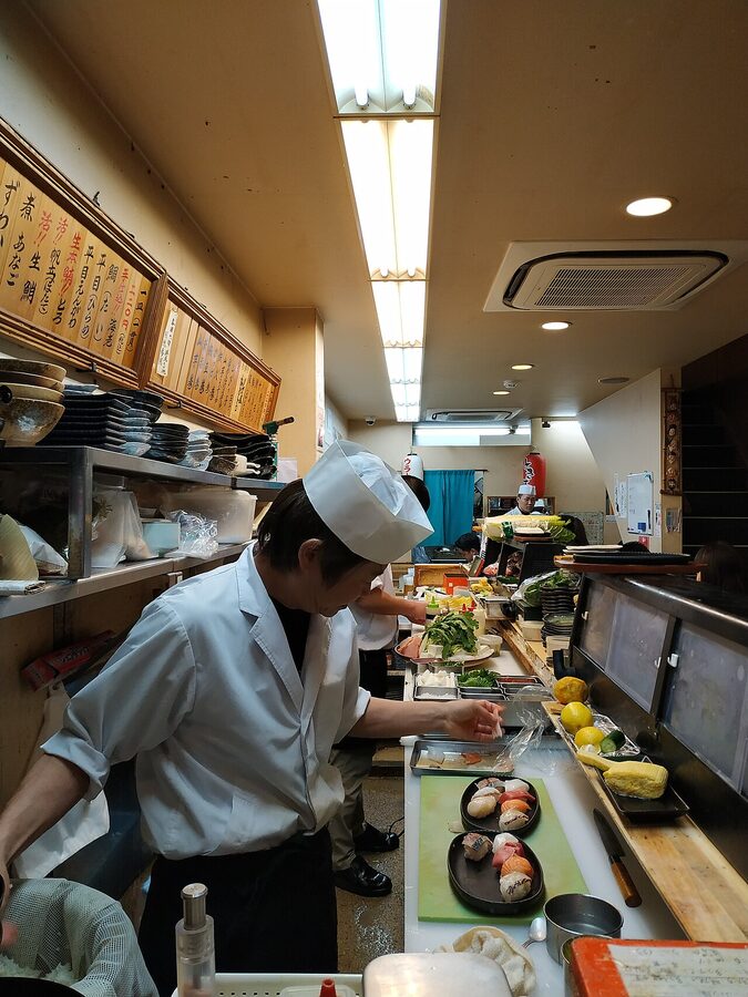 Sushi chefs working at a counter