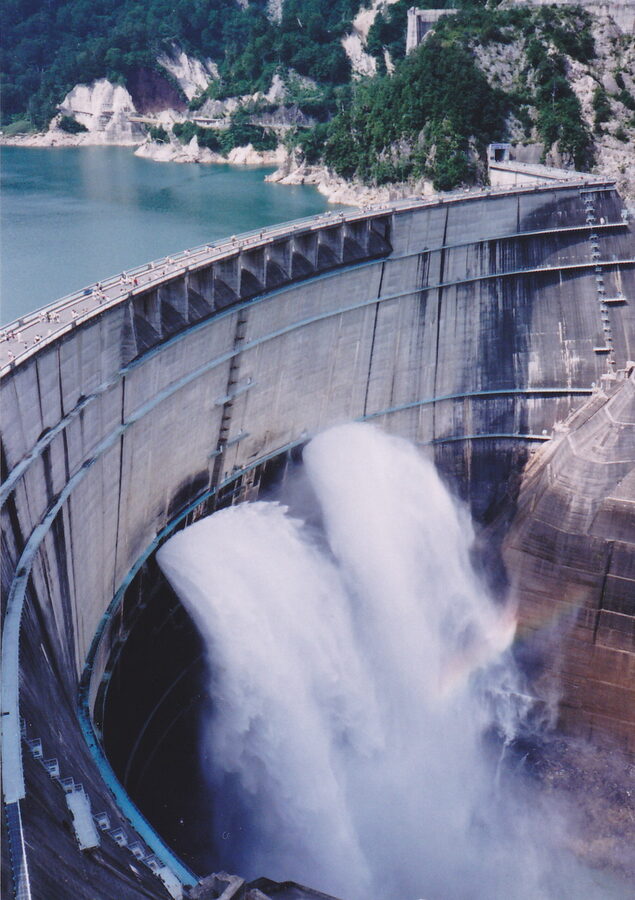 Rainbow over the Kurobe Dam discharge column on a sunny morning