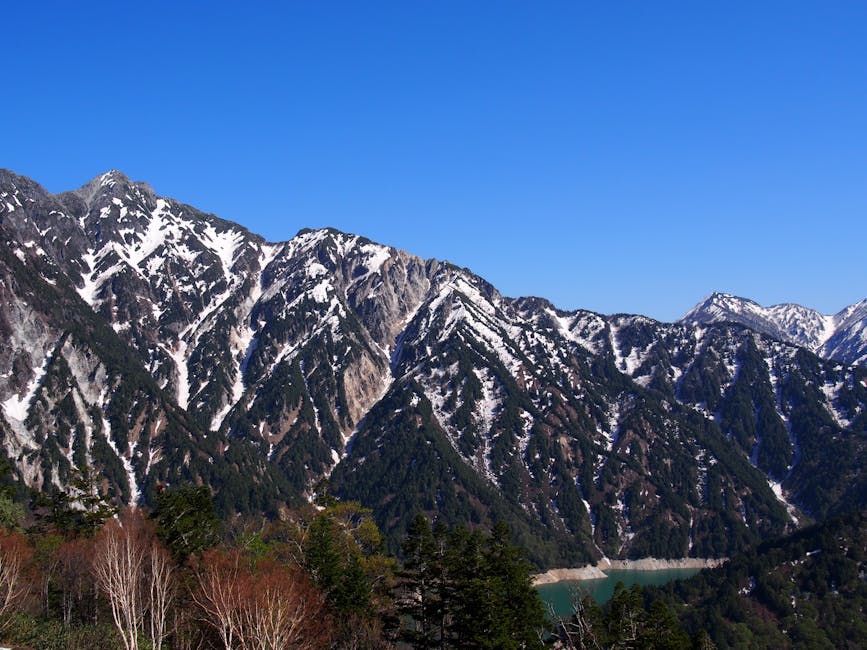 Snowy mountains rising above the Kurobe gorge area in late spring